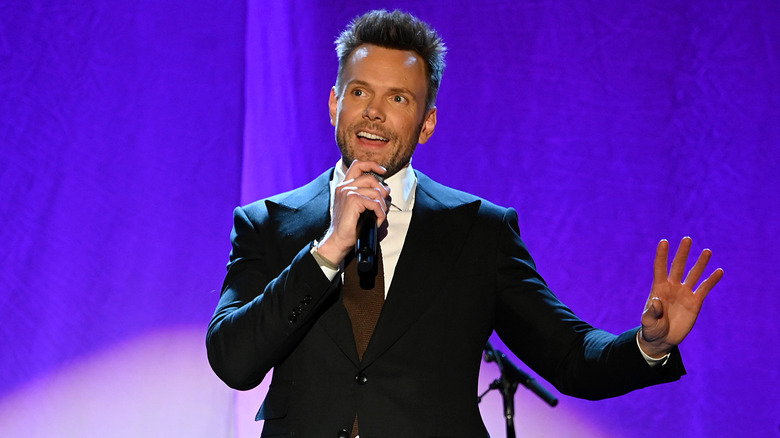 Joel McHale performing on stage