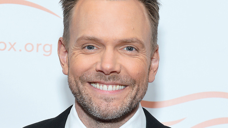 Joel McHale smiling on red carpet