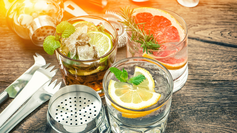 Three cocktails with garnish on top