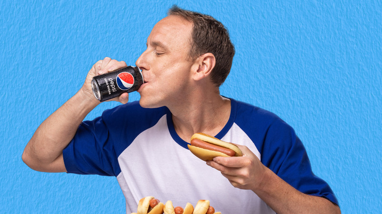 Joey Chestnut with a Pepsi and hot dog