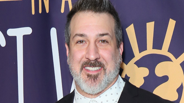 Joey Fatone in front of purple background