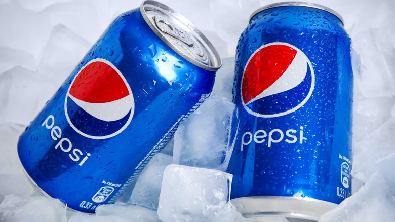 Pepsi cans on ice cubes
