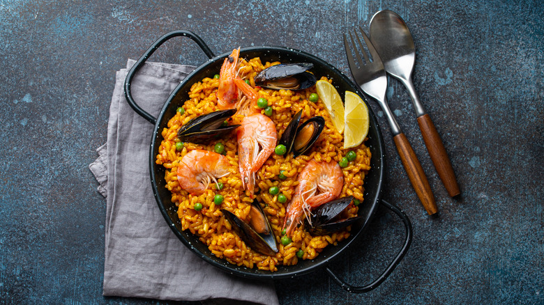 Seafood paella in black ceramic serving dish