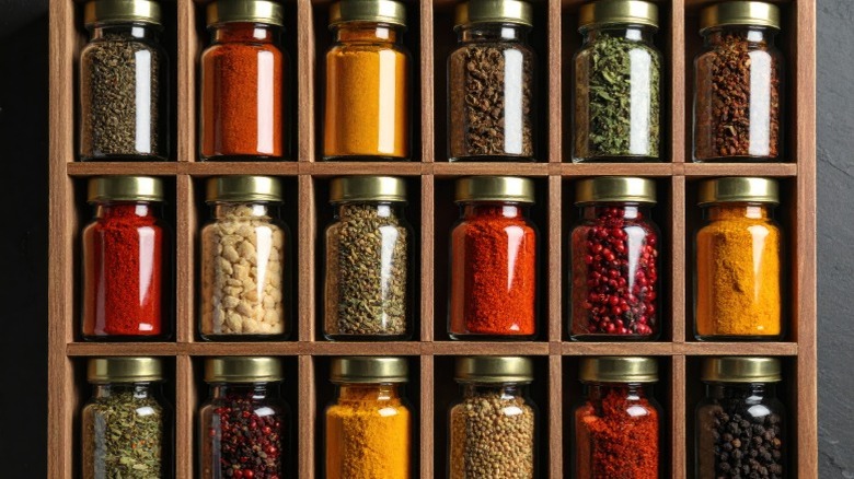 Assorted jarred spices on a spice rack