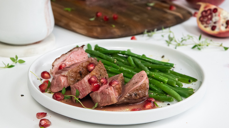 duck dish with pomegranate sauce and vegetables