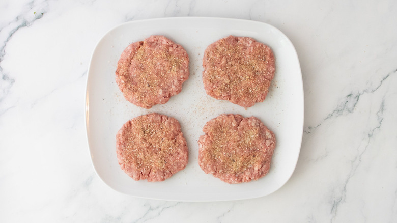 Seasoned lamb patties on plate