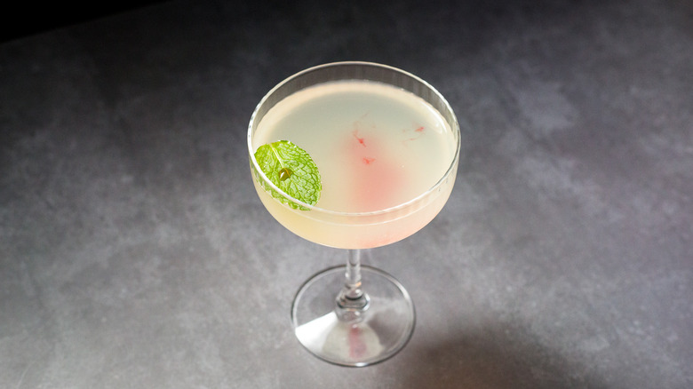 garnished cocktail on gray background