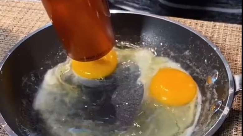 hair drying eggs in a pan