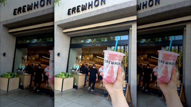 Erewhon smoothie being held up in front of store