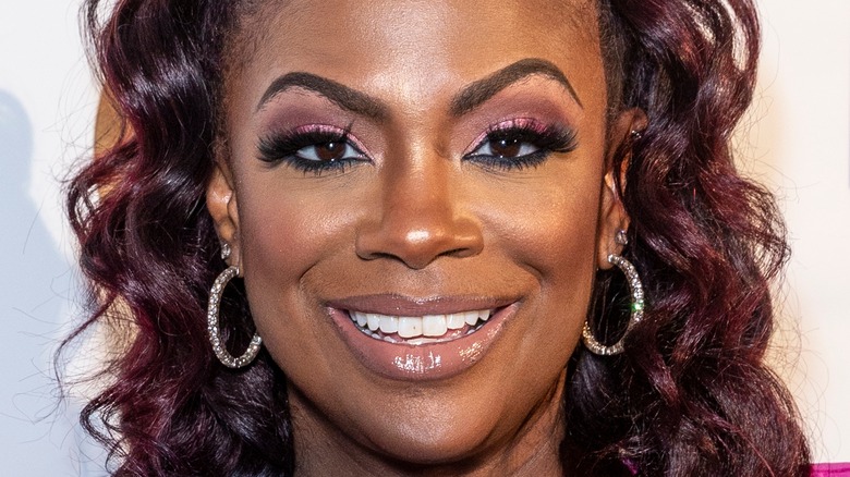 Kandi Burruss smiles with updo