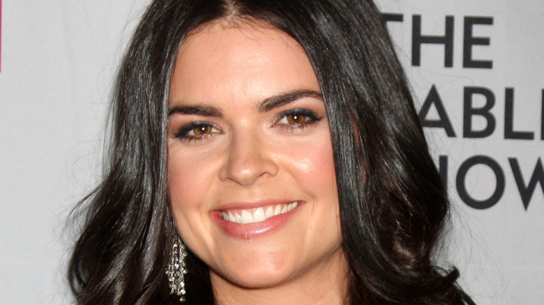 Katie Lee smiles with dangling earrings