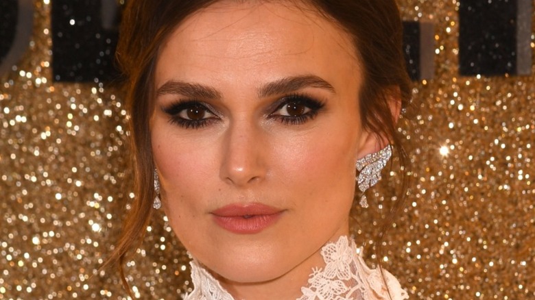 Actress Keira Knightley with diamond earrings and a lace top