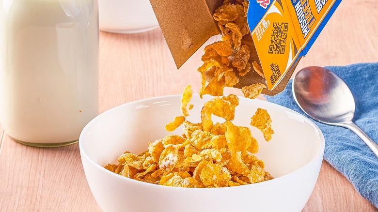 Pouring Frosted Flakes into bowl
