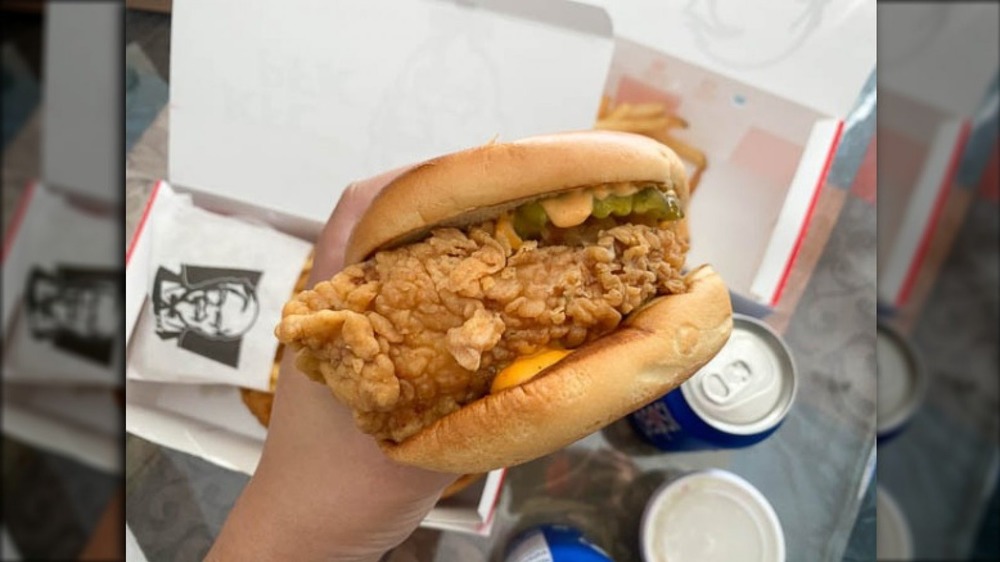 Hand holding new KFC chicken sandwich