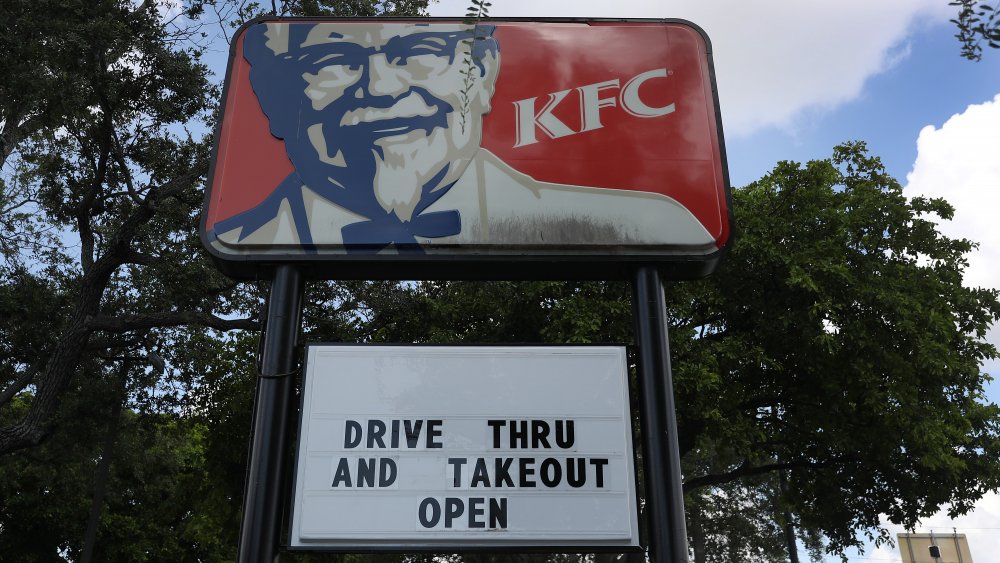 KFC sign with readerboard: "drive thru and takeout open"