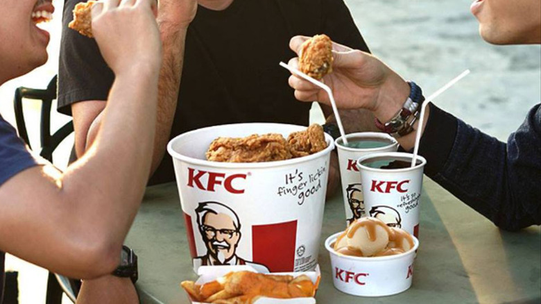 Three people enjoying KFC 