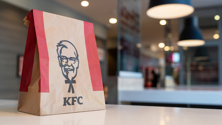 KFC bag with food on table in restaurant