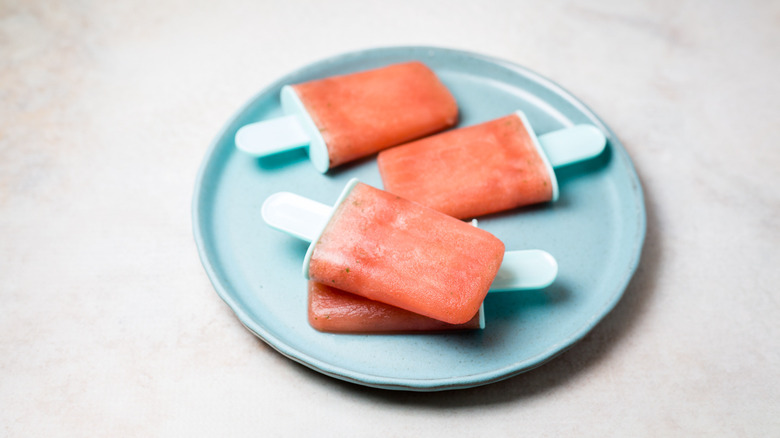 watermelon popsicles on blue plate