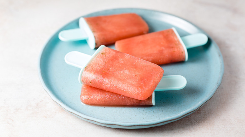 watermelon popsicles on blue plate