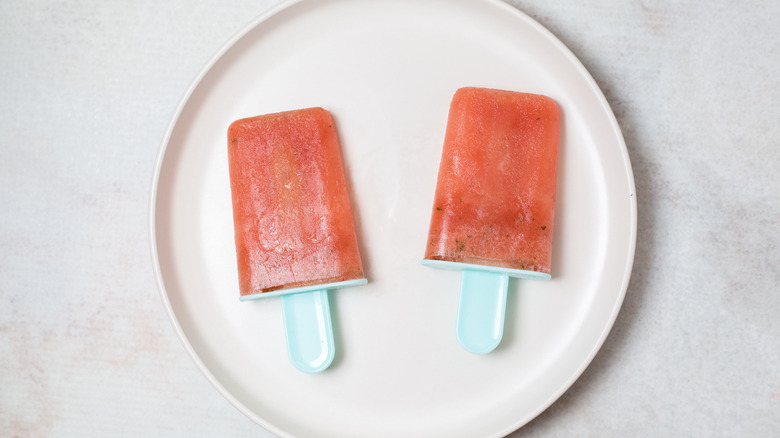 watermelon popsicles on white plate
