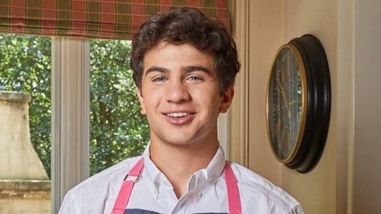 Matthew Merrill wearing apron in kitchen