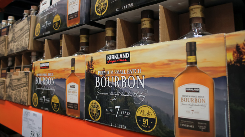 Cases of Kirkland Signature small batch bourbon on shelf in Costco.