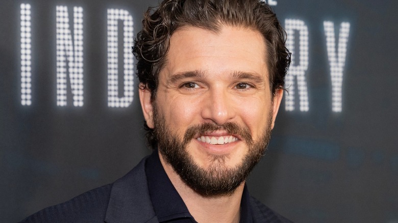 Kit Harington smiling at a red carpet event.