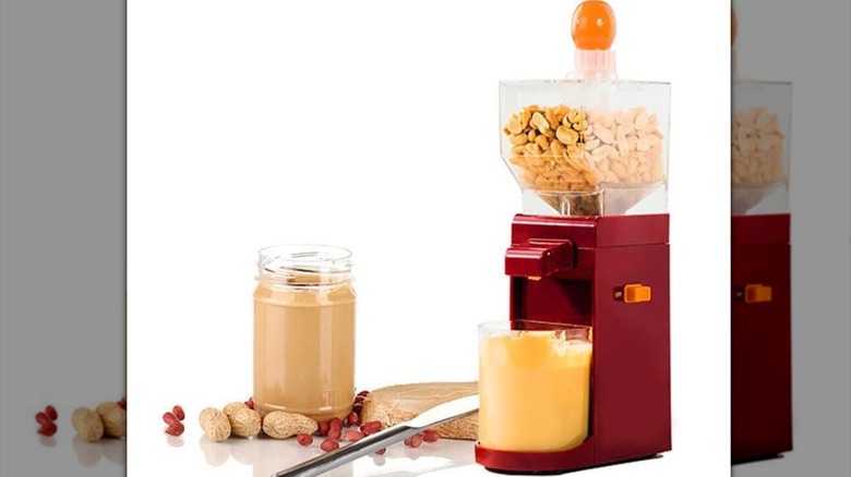 Old fashioned style peanut butter machine with peanuts