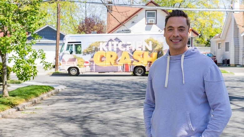 Jeff Mauro standing in front of a Kitchen Crash bus