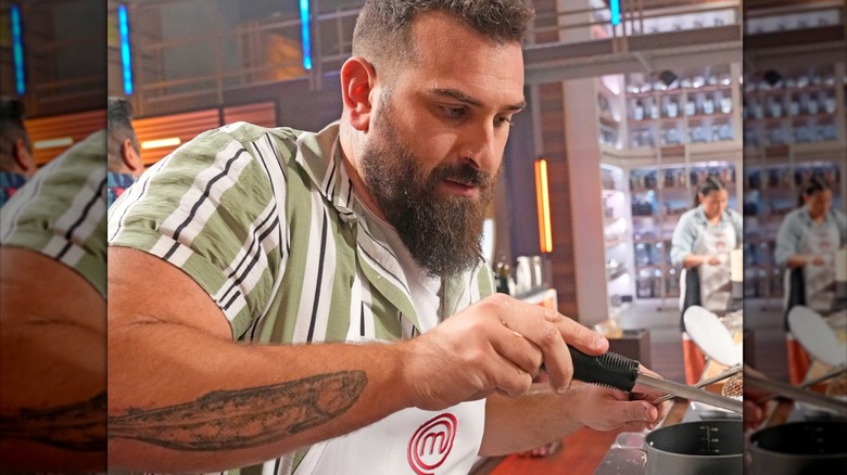 MasterChef contestant with long beard cooking