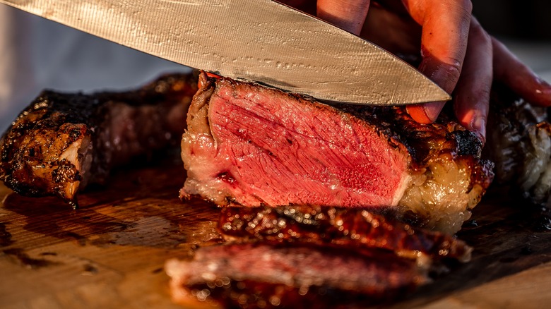 Man cuts steak