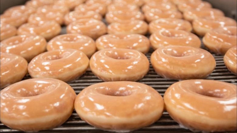 Krispy Kreme's glazed doughnuts on a conveyor belt