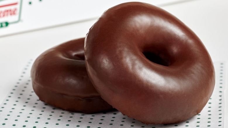 Two chocolate glazed Krispy Kreme doughnuts