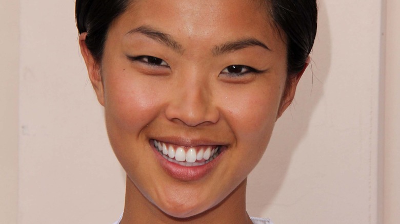 Kristen Kish smiles with hair pulled back