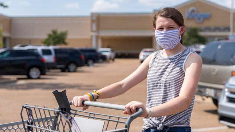 Masked Kroger shopper with cart