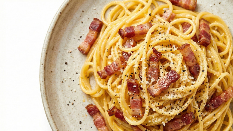 Top-down view of spaghetti carbonara with small chunks of bacon