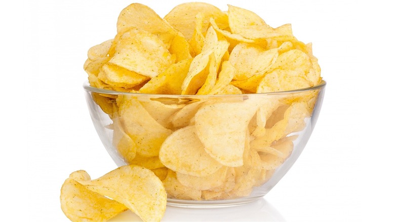 Potato chips in a clear glass bowl. 