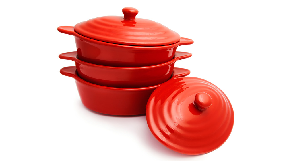 Three Le Creuset red pots