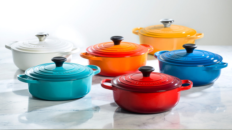 Le Creuset pots of varying colors on display