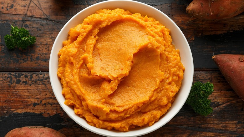 mashed sweet potato in white bowl