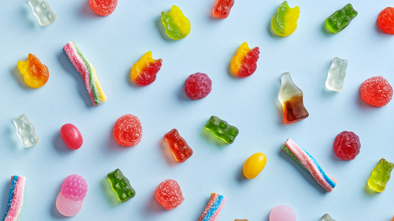 assortment of gummy candies on blue background