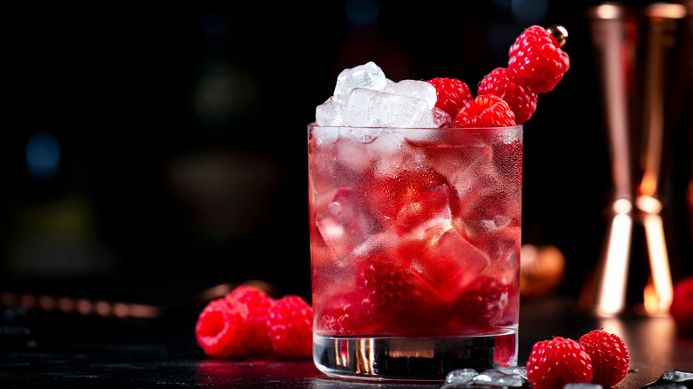 Gin and tonic loaded with ice and raspberries