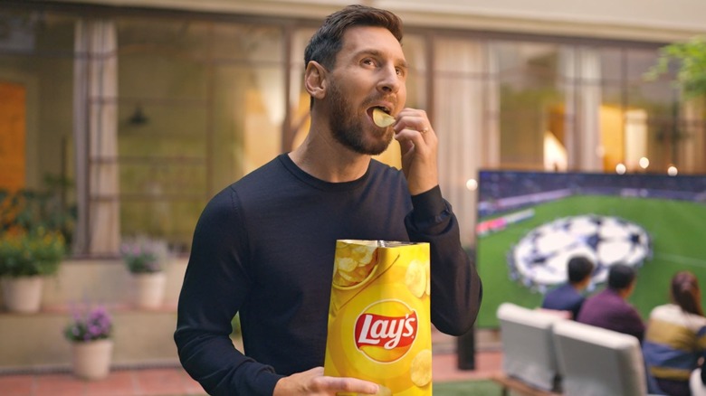 Lionel Messi eating Lays potato chips