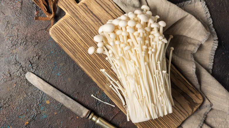 Enoki mushroom on brown wood