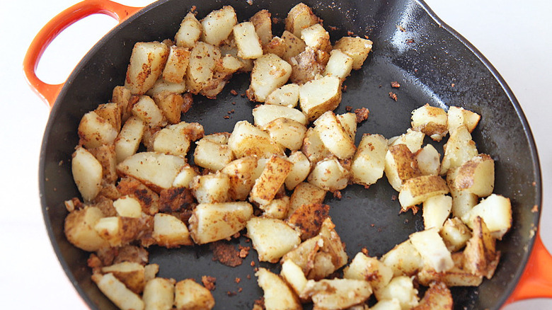 potatoes cooking in skillet
