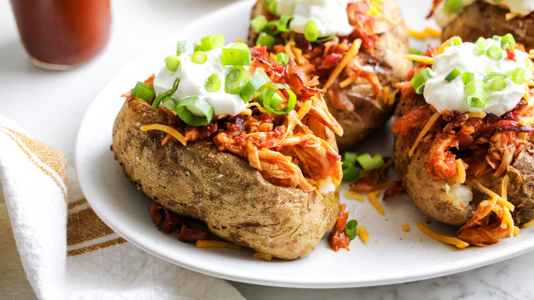 loaded chicken bbq baked potatoes on plate