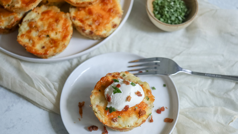 loaded mashed potato cup on plate with fork