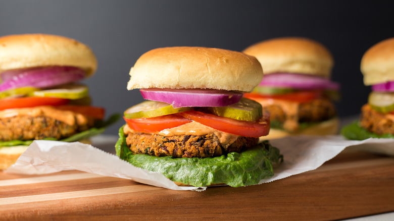 Veggie burgers with lettuce, tomato, pickle, and onion toppings
