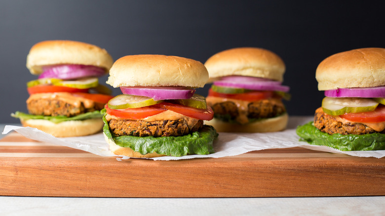 veggie burgers on wooden board