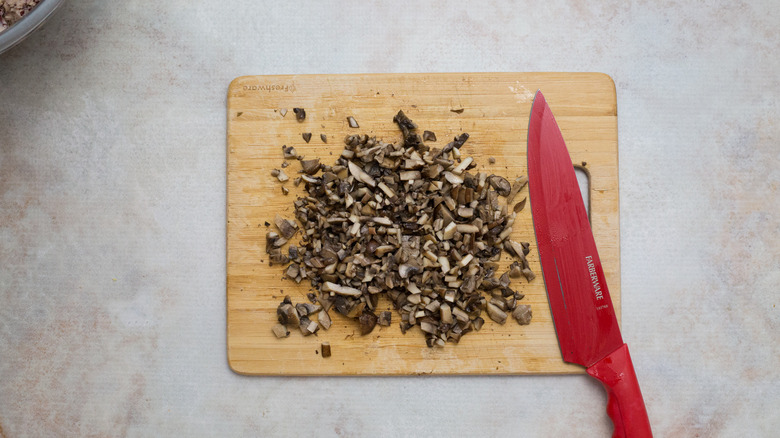 chopped mushrooms on wooden board
